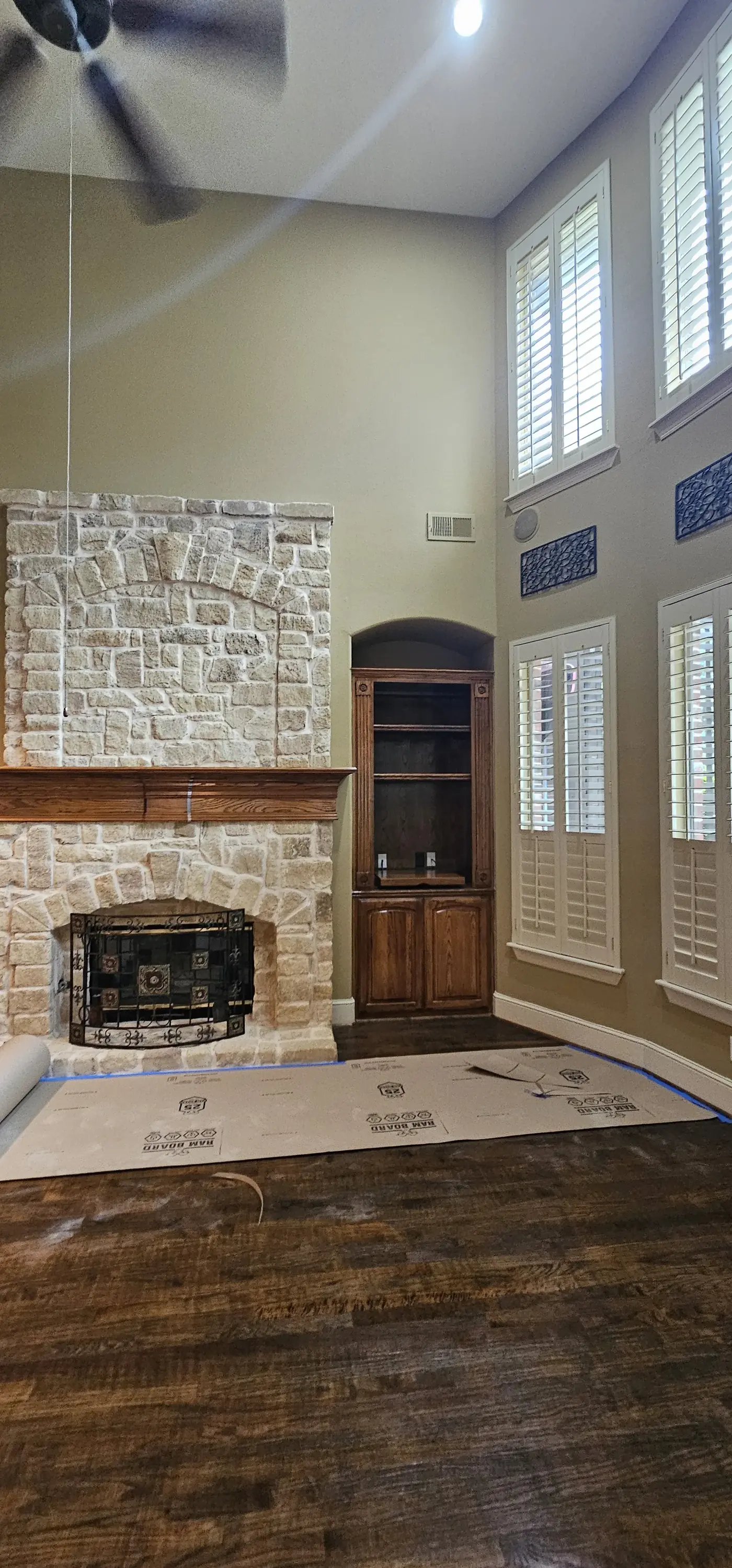 Stone fireplace area with dated cabinetry