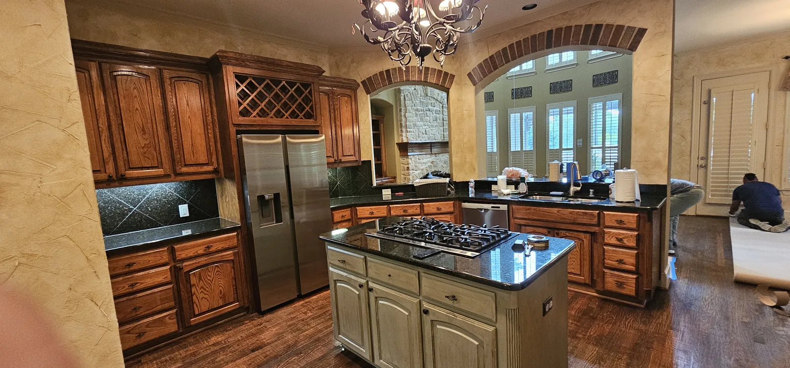 Dated kitchen with dark cabinets and granite